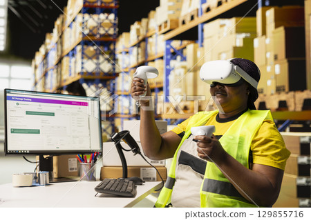 Depot clerk uses virtual reality headset to manage order processing and parcel status, AI powered setup enhances logistics and fast delivery operations with virtual reality tools. 129855716