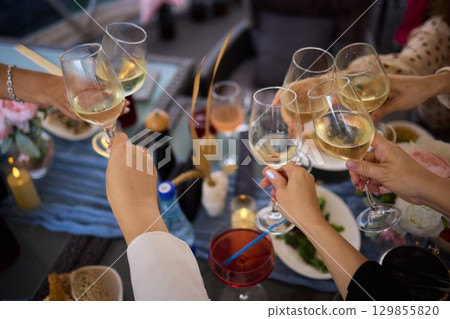 A Celebration Toast featuring beautifully crafted Champagne Glasses filled with bubbly drink 129855820