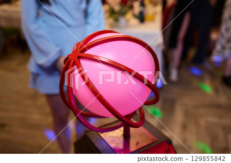 A colorful Balloon Hat adds fun and creativity to a lively community event celebration 129855842