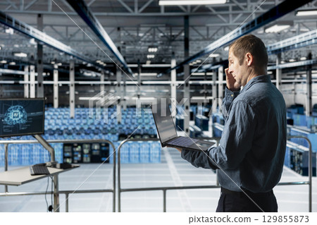 Data center computer scientist reviewing code for AI automation scripts. Server hub IT expert runs neural networks assisted diagnostics on infrastructure for predictive fault detection 129855873