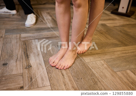 Feet Together on a Smooth Wooden Floor Creating a Relaxing and Inviting Atmosphere Feet Together on a Smooth Wooden Floor Creating a Relaxing and Inviting Atmosphere 129855880