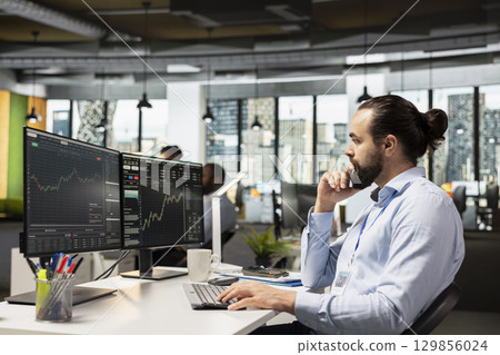 Trader in prop firm office analyzing market data and executing trades using trading software interface on PC. Stockbroker working for asset management company monitoring stock prices using computer Trader in prop firm office analyzing market data and executing trades using trading software interface on PC. Stockbroker working for asset management company monitoring stock prices using computer 129856024