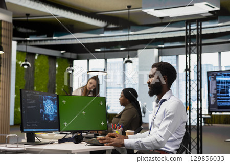 Admin using mockup PC to adjust machine learning algorithms parameters, automating workflow. Tech company worker using AI insights for code optimization on green screen computer 129856033