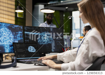 Female engineer developing applications using AI LLM chatbot on multiple devices. Worker doing internship in tech startup relying on artificial intelligence assistant to debug applications Female engineer developing applications using AI LLM chatbot on multiple devices. Worker doing internship in tech startup relying on artificial intelligence assistant to debug applications 129856313