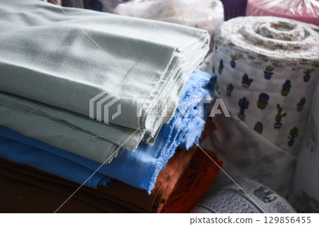 heap of colorful cloth on shelf for sale in store 129856455