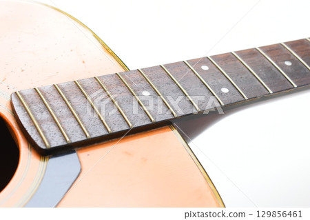 brown wood acoustic guitar isolated on white background brown wood acoustic guitar isolated on white background 129856461