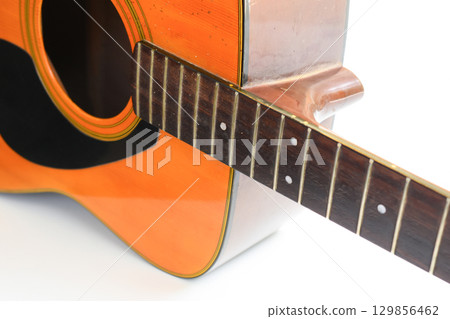 brown wood acoustic guitar isolated on white background brown wood acoustic guitar isolated on white background 129856462