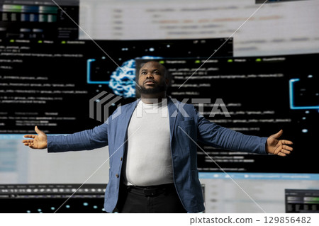 Black programmer specialist engaging in software development at a high tech workstation, focused on his screen. Showcasing coding life, IT algorithm, cloud computing in the tech world. Black programmer specialist engaging in software development at a high tech workstation, focused on his screen. Showcasing coding life, IT algorithm, cloud computing in the tech world. 129856482