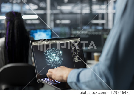 Close up of admin using laptop in data center, optimizing hardware for AI tasks. Server room IT worker using notebook, automating system diagnostics using deep learning predictions 129856483