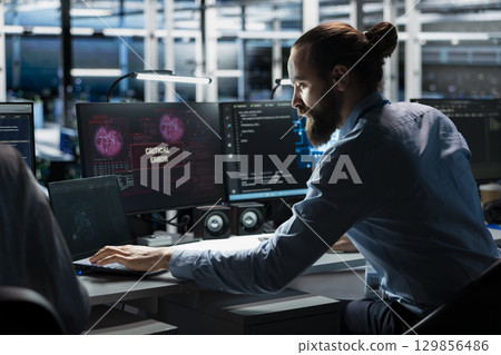 Data center technician using AI LLM assistant to fix critical errors affecting infrastructure. Server hub IT expert using large language model chatbot to eliminate computer bugs Data center technician using AI LLM assistant to fix critical errors affecting infrastructure. Server hub IT expert using large language model chatbot to eliminate computer bugs 129856486