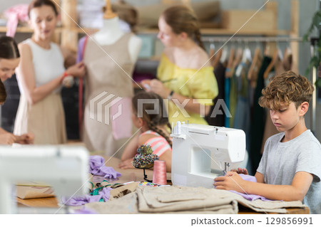 Portrait of teenage boy at sewing class Portrait of teenage boy at sewing class 129856991