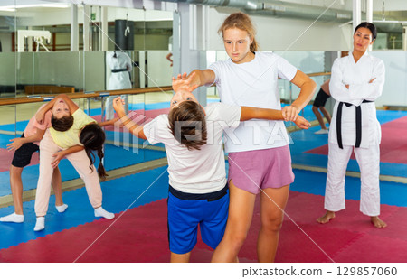 Young boys and girls learning self-protection moves Young boys and girls learning self-protection moves 129857060
