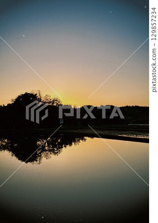 Sun reflected in fallow rice fields 03 Sun reflected in fallow rice fields 03 129857234