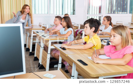 Kids listening to teacher Kids listening to teacher 129857246