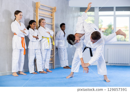 Coach and boy training judo technique Coach and boy training judo technique 129857391