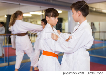 Kids sparring during karate training 129857554