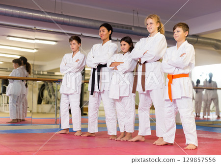 Portrait of coach with his karate students in sports club 129857556