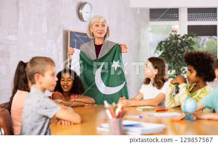 students listen to woman teacher who talks about Pakistan 129857567