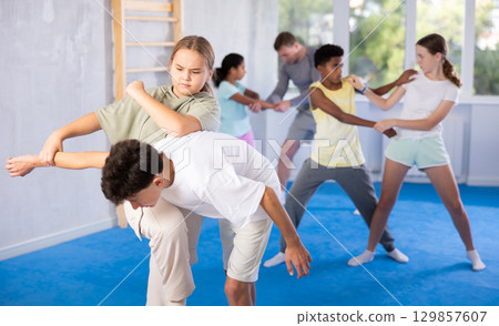 Boy and girl practicing self-defense techniques 129857607