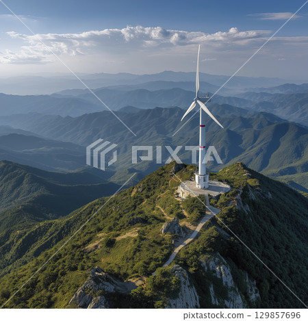 White wind turbine, red accent, remote mountain peak under bright sunny sky. Represents sustainable renewable energy, powerful symbol of hope for nature future 129857696