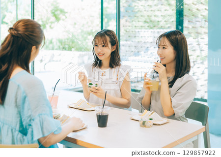 Three women having lunch at a cafe Three women having lunch at a cafe 129857922