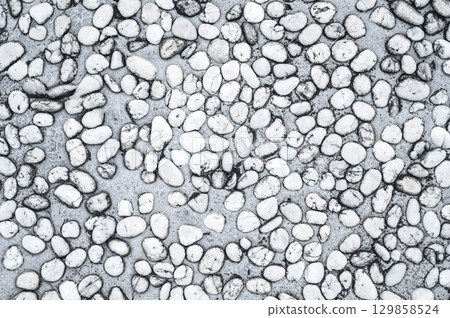 background with a sidewalk texture with white pebbles. Natural road surface 129858524