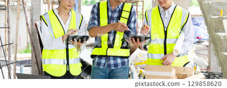 Engineer teams meeting working together wear worker helmets hardhat on construction site in city. Engineer teams meeting working together wear worker helmets hardhat on construction site in city. 129858620