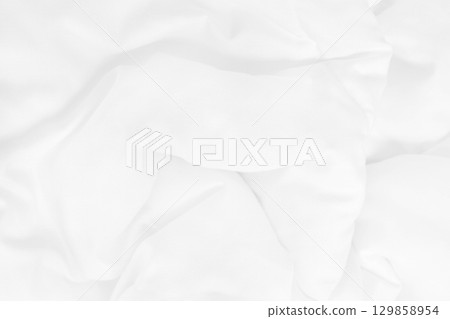 Close up top view of white bedding sheet and wrinkle messy blanket in bedroom after wake up in the morning. 129858954