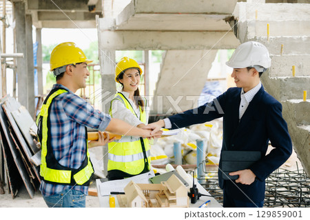 Engineer desk with object paper and tablet with blurry engineer teamwork hardworking to consults about their building 129859001
