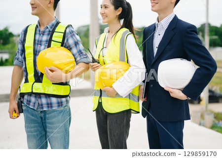Architect Asian team working with colleagues in the construction site. Architecture engineering on big project. Architect Asian team working with colleagues in the construction site. Architecture engineering on big project. 129859170