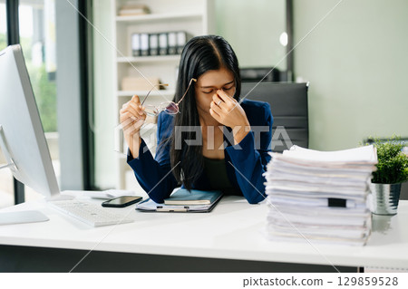 Asian businesswoman is stressed, bored, and overthinking from working 129859528