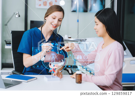 Woman Doctor and patient discussing something while sitting at the table . 129859817