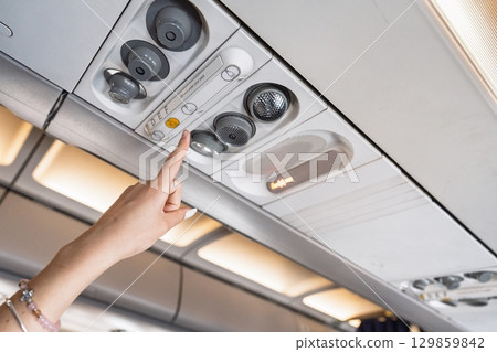 Activating Cabin Light Button In Commercial Airplane During Air Travel, Passenger Comfort 129859842