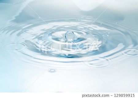 Drops of water falling on the surface of the water. Drops of water falling on the surface of the water. 129859915