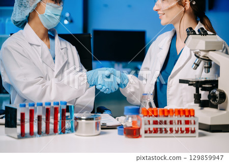 Scientists, beakers, and microscopes in cutting-edge research. Perfect for science and technology projects. Scientists, beakers, and microscopes in cutting-edge research. Perfect for science and technology projects. 129859947