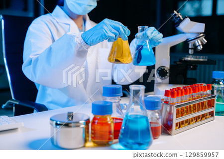 Female biotechnologist testing new chemical substances in a laboratory. 129859957