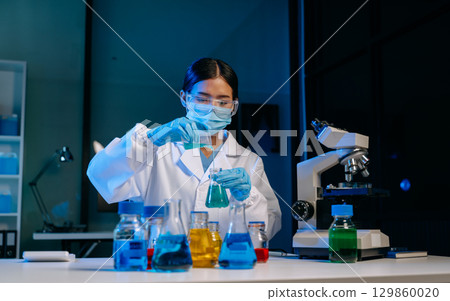 Scientists, beakers, and microscopes in cutting-edge research. Perfect for science and technology projects. 129860020