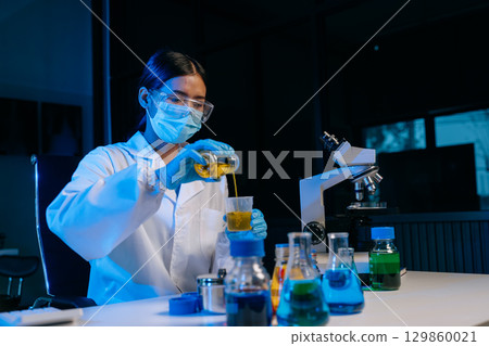 Scientists, beakers, and microscopes in cutting-edge research. Perfect for science and technology projects. 129860021