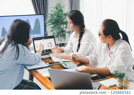 Financial business team in office, financial expert analyze business report graph and finance chart at corporate office. Concept of finance economy, banking business and stock market research. 129860381