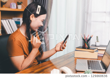 Homeschool Asian girl student learning virtual internet online class from school teacher by remote meeting. Female teaching math by headphone. education concept. student with computer study at school Homeschool Asian girl student learning virtual internet online class from school teacher by remote meeting. Female teaching math by headphone. education concept. student with computer study at school 129860636