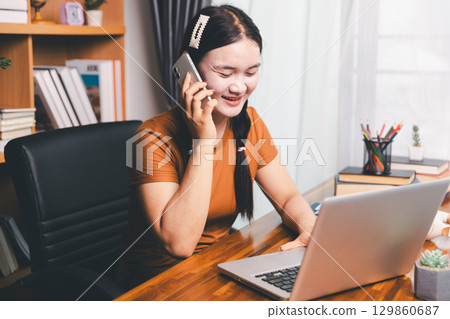 Homeschool Asian girl student learning virtual internet online class from school teacher by remote meeting. Female teaching math by headphone. education concept. student with computer study at school Homeschool Asian girl student learning virtual internet online class from school teacher by remote meeting. Female teaching math by headphone. education concept. student with computer study at school 129860687