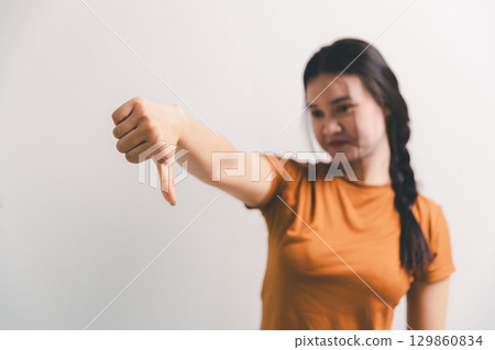 Asian girl expresses dislike, person express negative feeling, concept business complaint from customer ensuring employee satisfaction negative feedback to prevent mental strain customer dislike Asian girl expresses dislike, person express negative feeling, concept business complaint from customer ensuring employee satisfaction negative feedback to prevent mental strain customer dislike 129860834