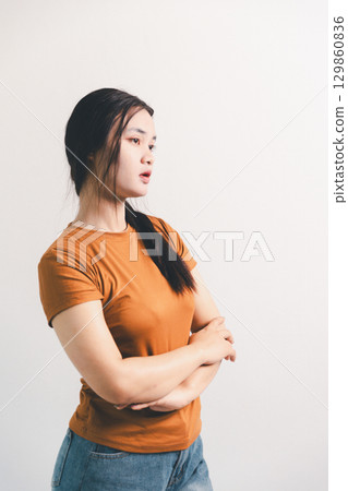 Asian girl expresses dislike, person express negative feeling, concept business complaint from customer ensuring employee satisfaction negative feedback to prevent mental strain customer dislike Asian girl expresses dislike, person express negative feeling, concept business complaint from customer ensuring employee satisfaction negative feedback to prevent mental strain customer dislike 129860836
