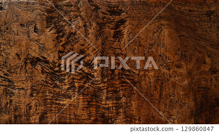 A background image of a long brown board with a complex, rough wood grain pattern 129860847