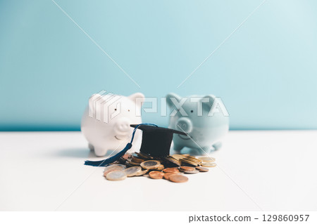 Concept of saving money for education, student loan, scholarship in future. Piggy bank with graduation hat, stack of coins. Earth globe with graduation hat, dollar banknotes on table. Tuition fees Concept of saving money for education, student loan, scholarship in future. Piggy bank with graduation hat, stack of coins. Earth globe with graduation hat, dollar banknotes on table. Tuition fees 129860957