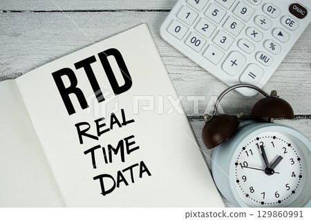 RTD Real Time Data text on paper notebook page with alarm clock and calculator on wooden background RTD Real Time Data text on paper notebook page with alarm clock and calculator on wooden background 129860991