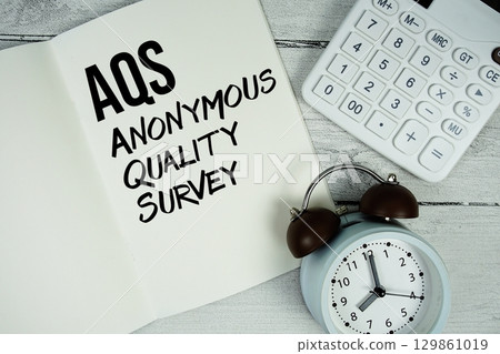 AQS Anonymous Quality Survey text on paper notebook page with alarm clock and calculator on wooden background AQS Anonymous Quality Survey text on paper notebook page with alarm clock and calculator on wooden background 129861019