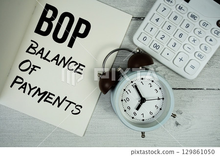 BOP Balance Of Payments text on paper notebook page with alarm clock and calculator on wooden background BOP Balance Of Payments text on paper notebook page with alarm clock and calculator on wooden background 129861050