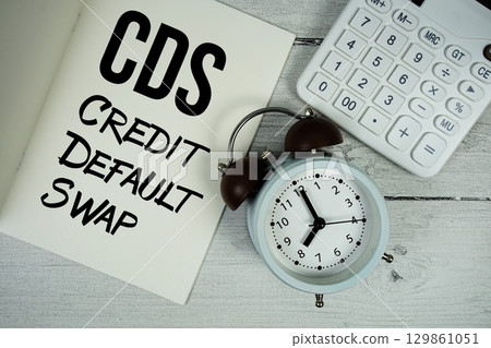 CDS Credit Default Swap text on paper notebook page with alarm clock and calculator on wooden background CDS Credit Default Swap text on paper notebook page with alarm clock and calculator on wooden background 129861051