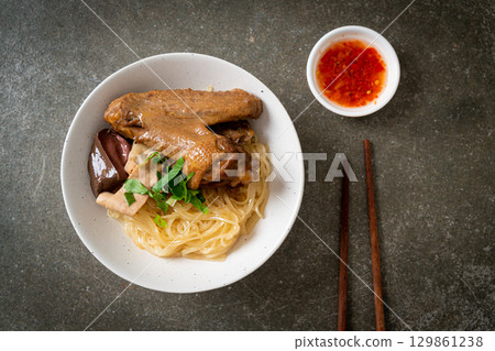 dried noodles with braised duck in white bowl dried noodles with braised duck in white bowl 129861238
